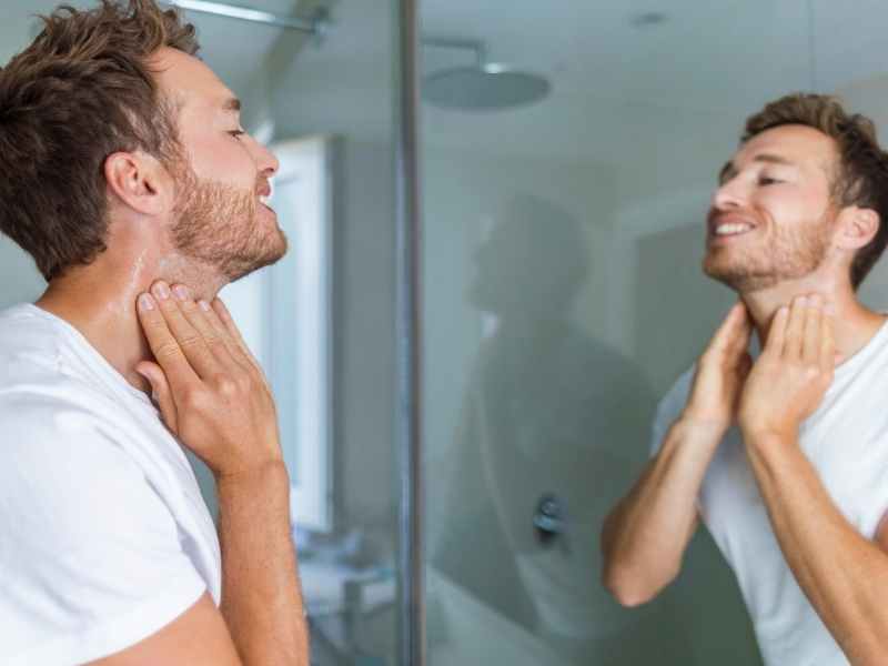 man shaving his neck